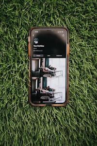 black samsung galaxy smartphone on green grass